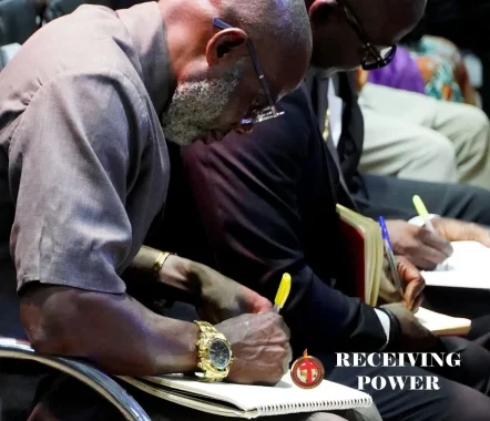 man writing during church sermon