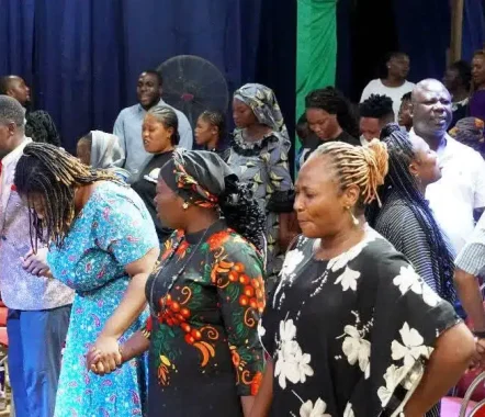 women praying during service in dopa